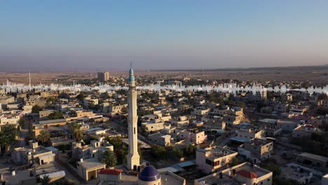 aerial view of a middle eastern town with a mosque