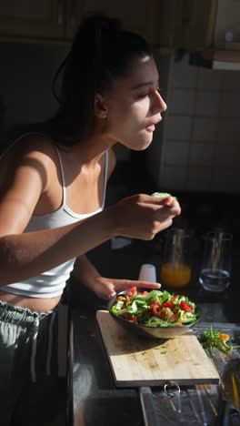 woman preparing a fresh salad in the kitchen