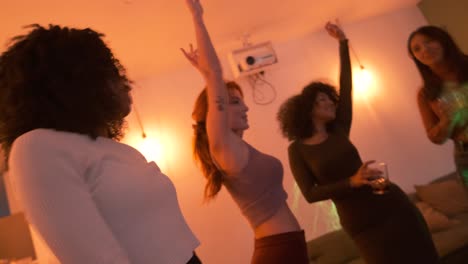 multiethnic friends grooving to music while enjoying weekend party at home