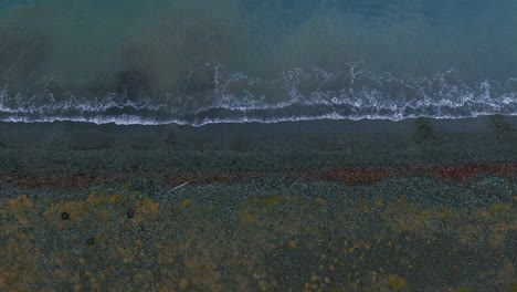 Waves-crashing-ashore-below-mountain-view-in-Iceland