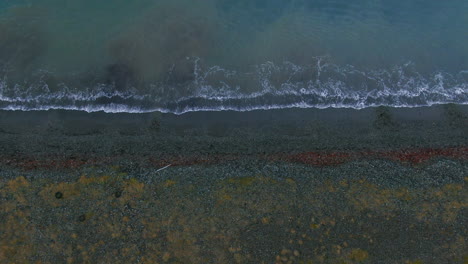 waves crashing ashore below mountain view in iceland