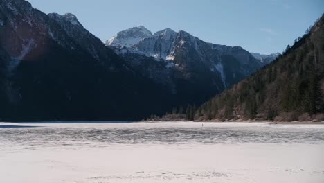 Lago-del-Predil,-Tarvisio---Italy-a-frozen-alpine-lake-in-a-snow-covered-winter-fairytale-mountain-landscape