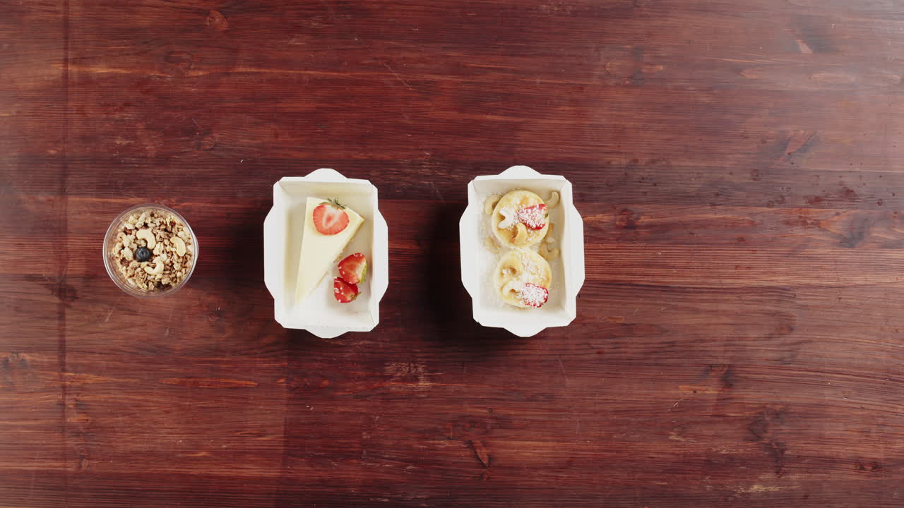 Hands Arranging Assortment of Desserts and Breakfast Food on Wooden Table
