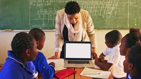 teacher and pupils with laptop in class 4k