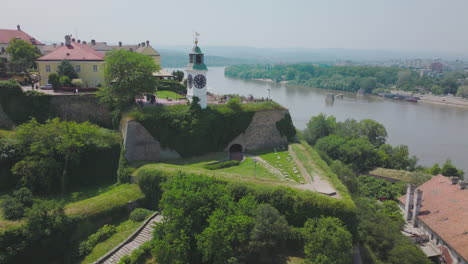 aerial view of a fortress with a clock tower and river