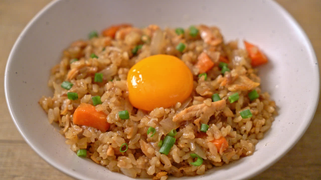arroz frito con salmón con huevo en escabeche encima - estilo de comida asiática