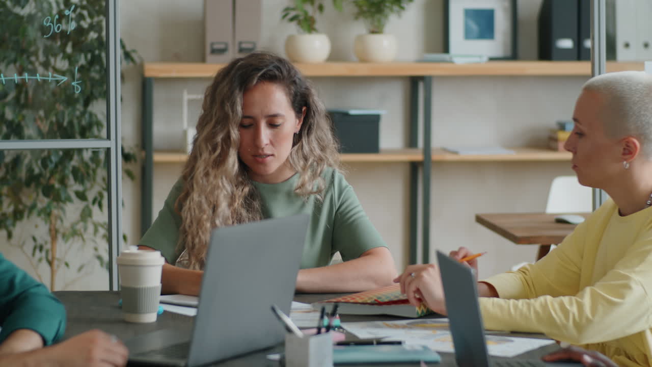Businesswoman Talking with Team at Office Meeting