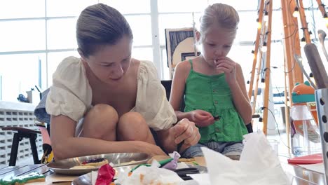 mother and daughter decorating cookies