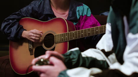 young person playing the guitar