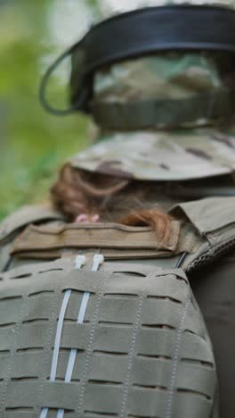 person wearing tactical gear in forest