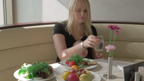 a woman with a baby on her lap is having a meal