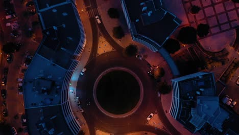 aerial top view of cars in roundabout in lisbon city, blue and orange colors