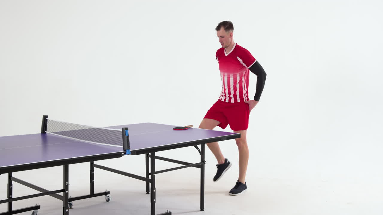 Male table tennis player warming up before game of table tennis on white background, copy space
