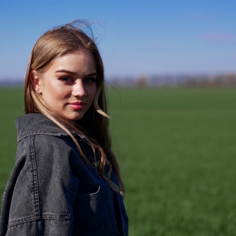 Portrait of attractive young woman outdoors. Pretty model in the countryside. Beautiful village girl posing on camera on nature background
