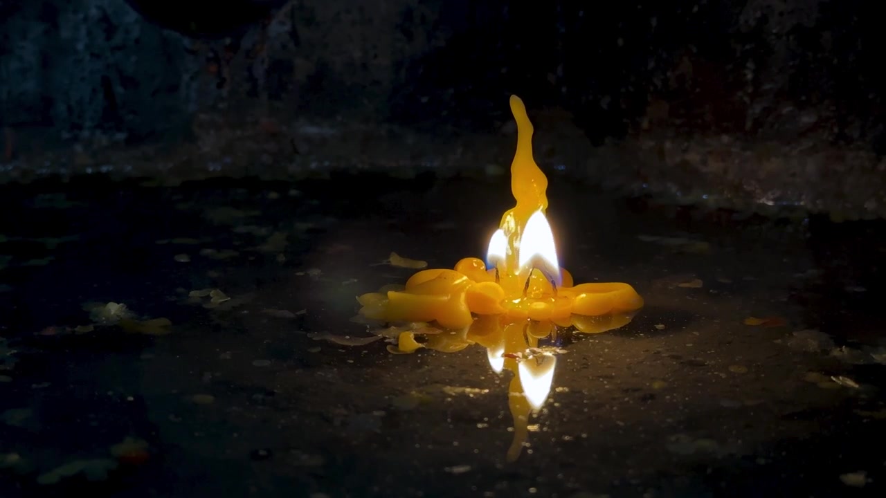 solitary candle flame on candlestick water reflection sand texture in church interior sacred worship for prayer in darkness dim room vibe atmosphere of spiritual ritual glow shadow cinematic Yerevan