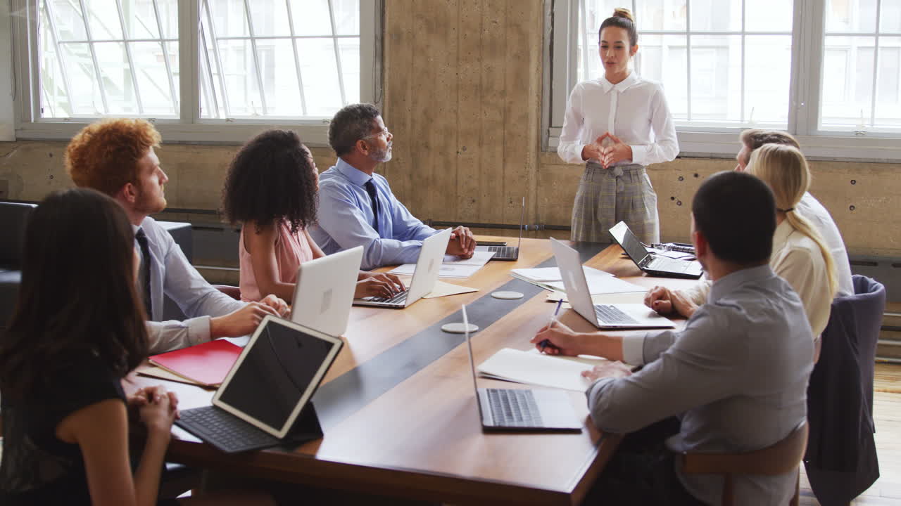 Female boss leading a meeting with colleagues in a boardroom
