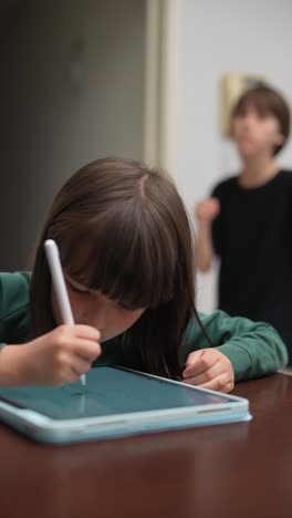 young girl drawing on a tablet
