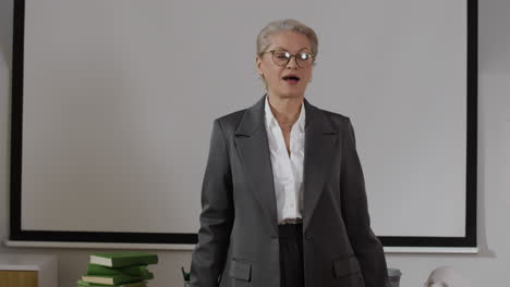 a teacher in a classroom giving a presentation