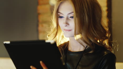 beautiful young woman enjoying a the tablet in a cafe hd video