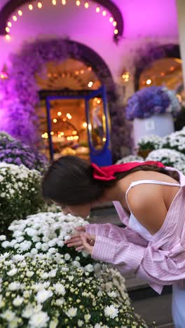 woman admiring flowers at an outdoor event