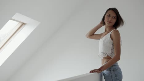 woman in a white lace crop top and jeans