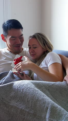 man giving a surprise gift to her woman