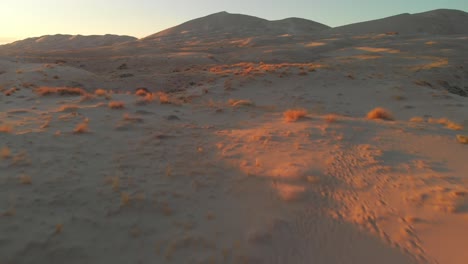 desert surface during sunset, low flight over kelso dunes in united states