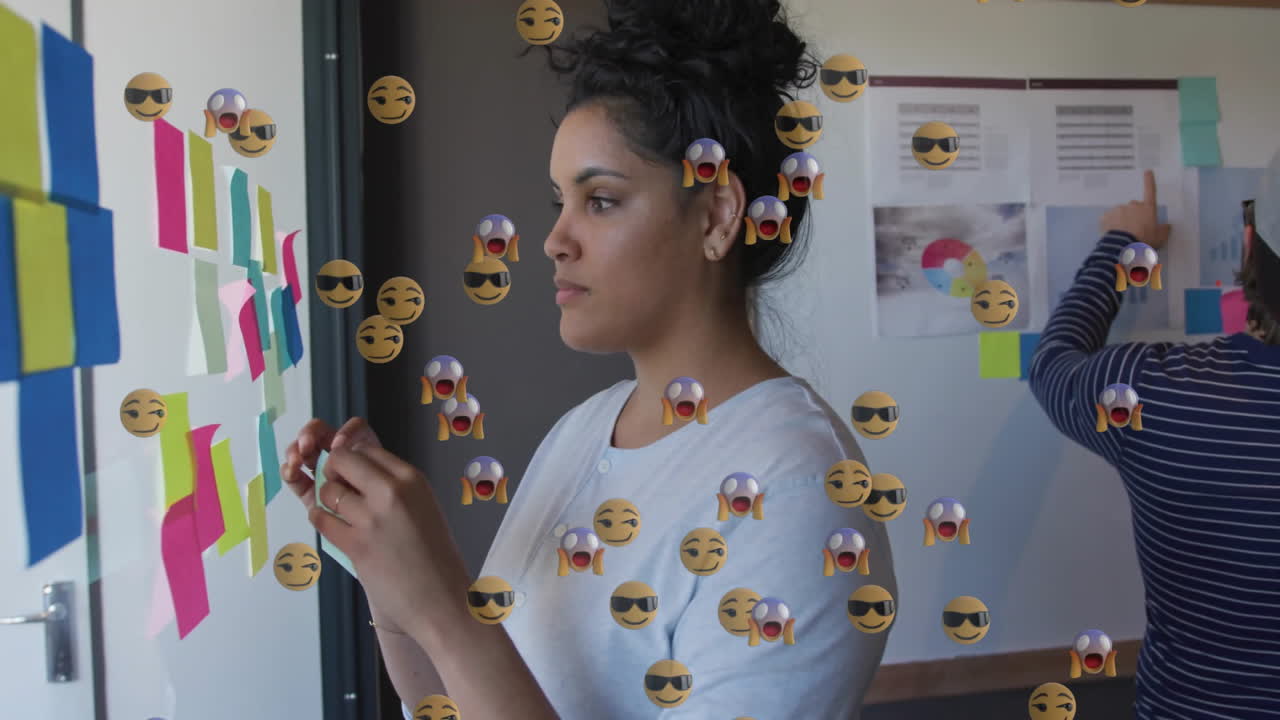 Colleagues collaborating in business meeting room, with animated sticky note and graph overlays