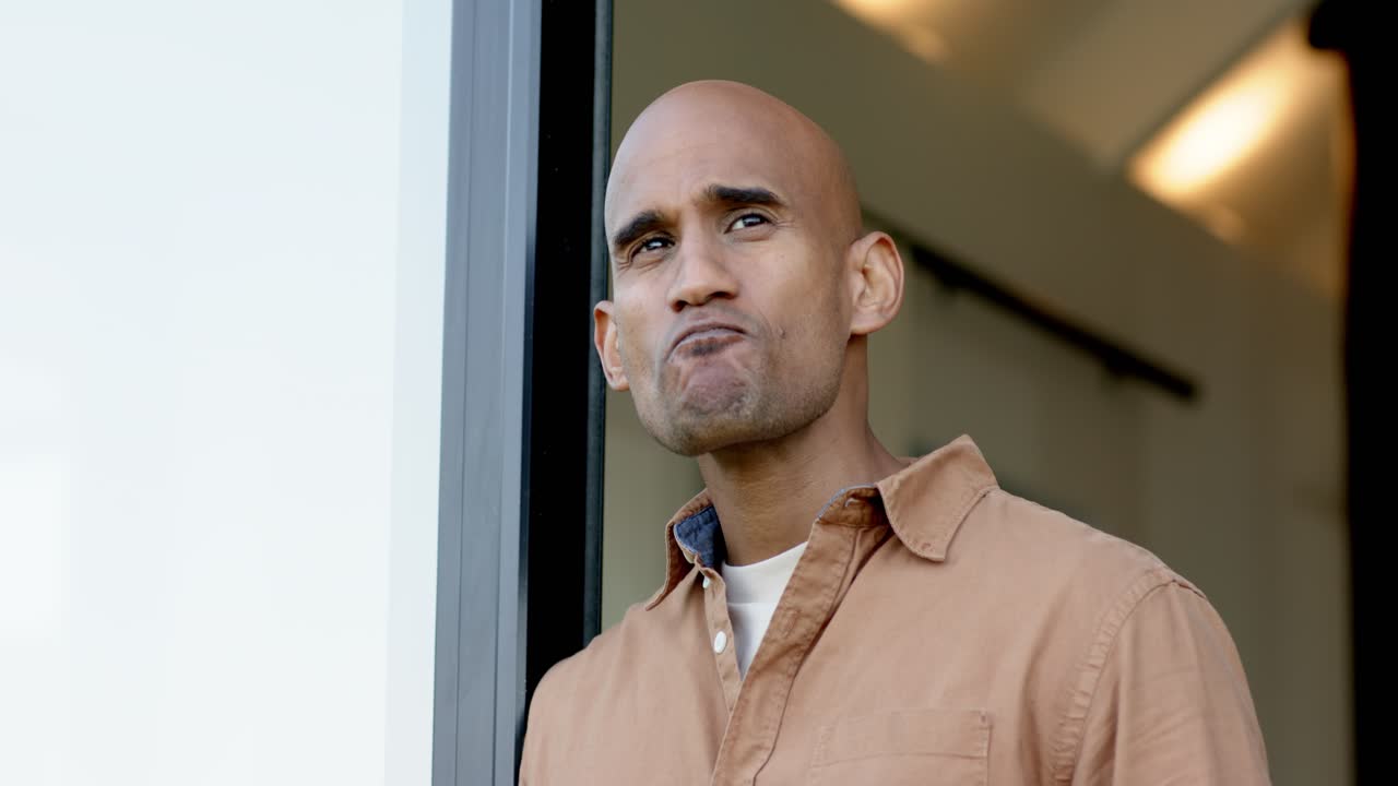 Entering threshold, mature man raising mug to lips, sipping coffee to savor before gazing outward