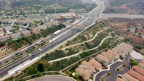 Aerial-view-of-traffic-in-the-Santa-Clarita-neighborhood,-cloudy-day,-in-Los-Angeles,-California,-USA---dolly,-drone-shot