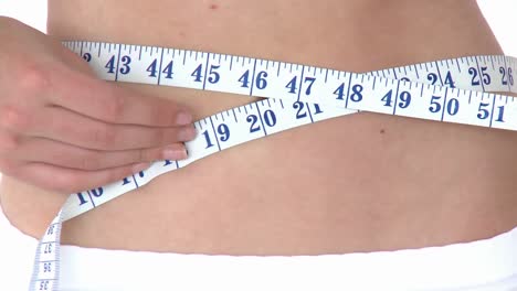 positive woman measuring her waist with a tape measure