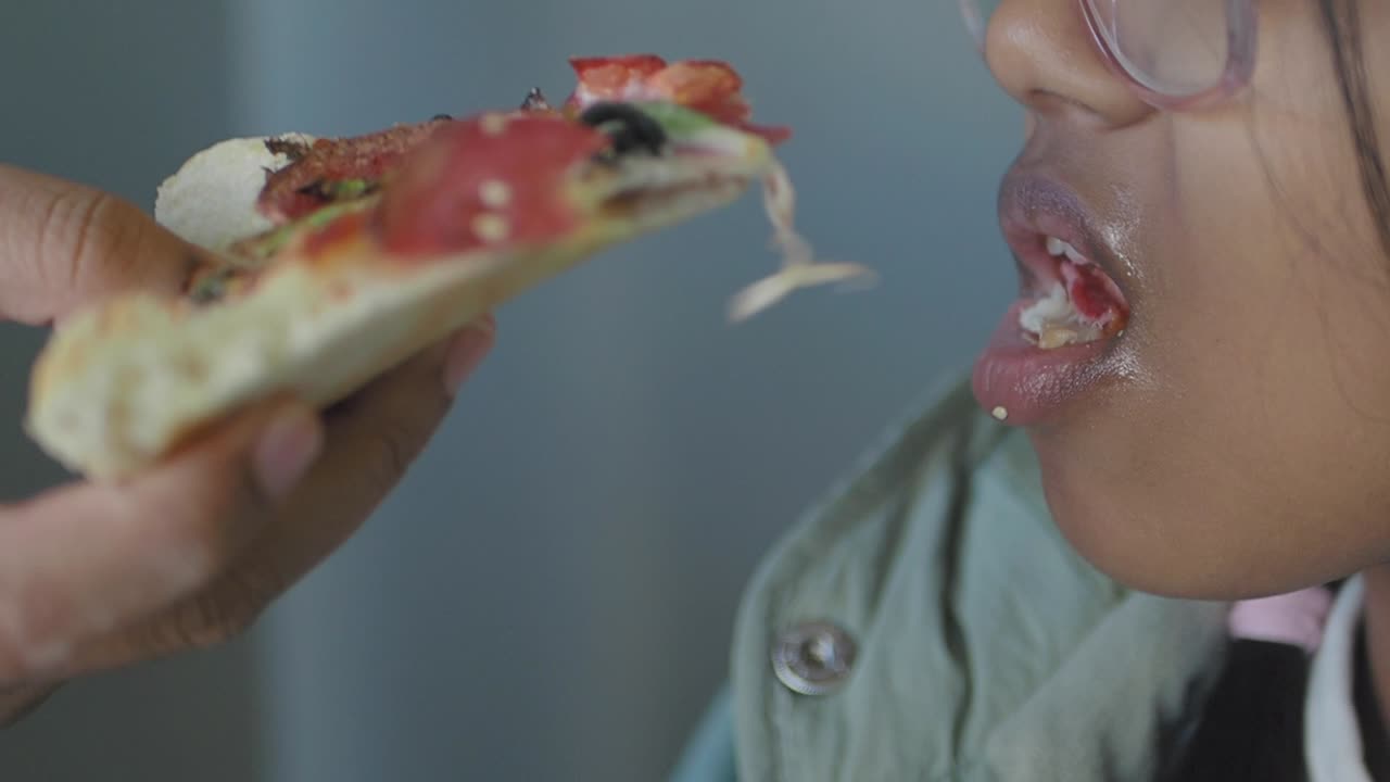 Girl Eating a Pizza Slice