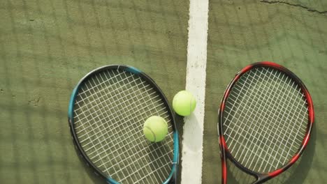 video of tennis racket and tennis ball on the green court