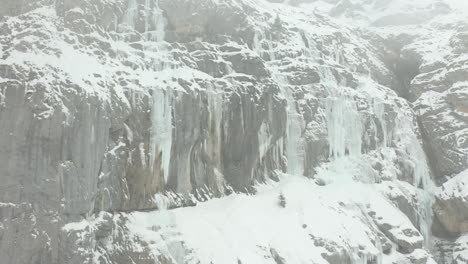 jib up of large icicles hanging of mountain wall