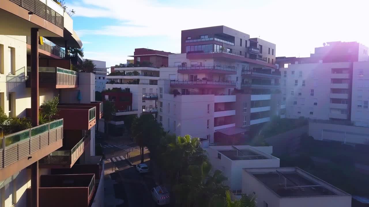 aerial view of a modern street with new and modern buildings, surrounded by vegetation