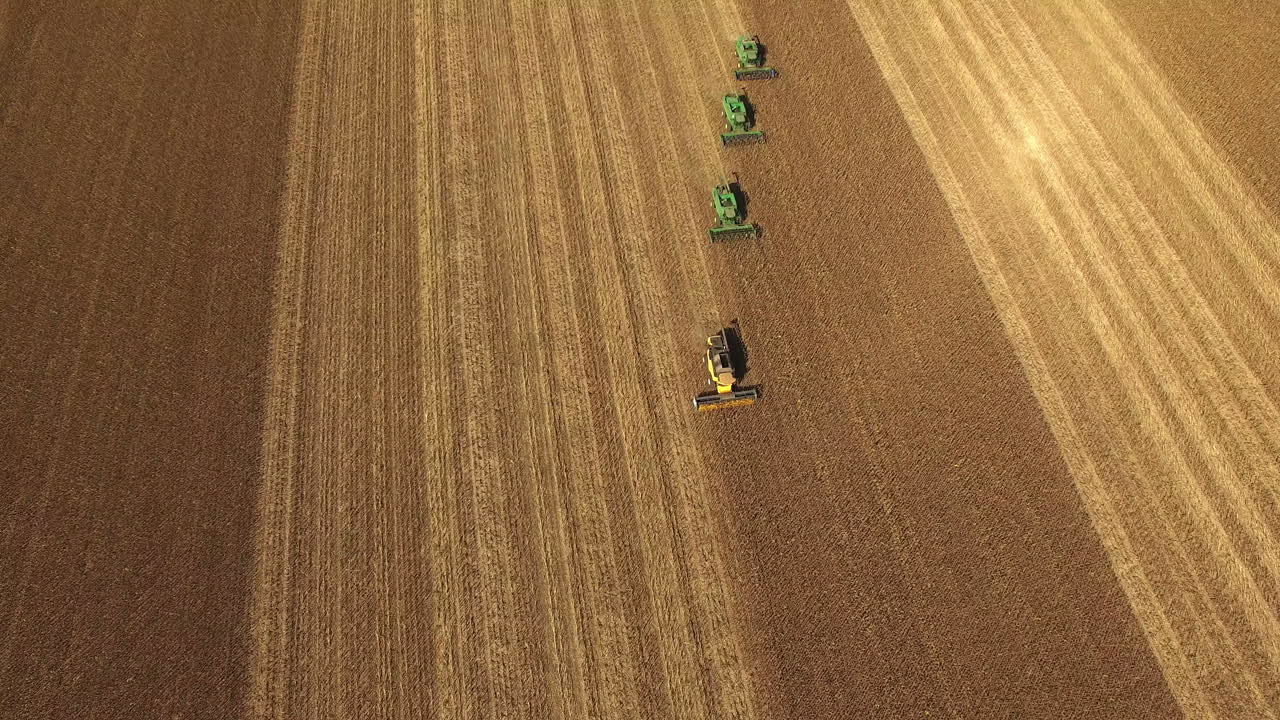 Aerial view of combine harvesters working in a field