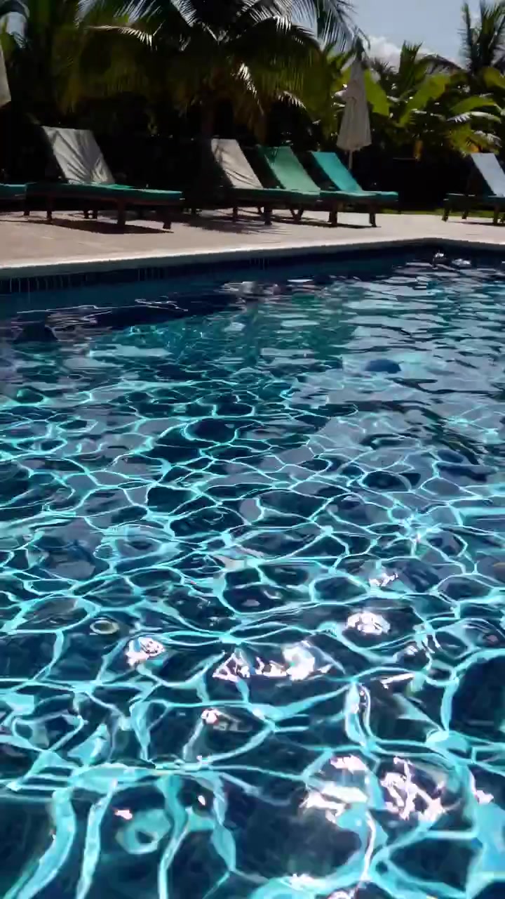 Sonnenlicht spiegelt sich auf tropischer Pool-Wasseroberfläche