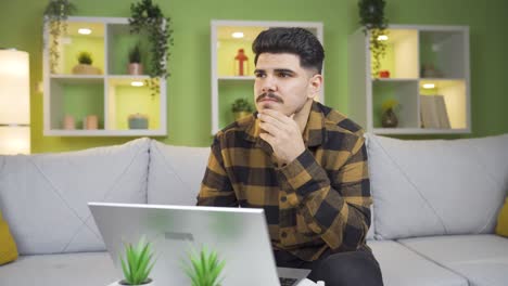 Thoughtful-young-man.-He-writes-what-he-thinks-on-the-laptop.