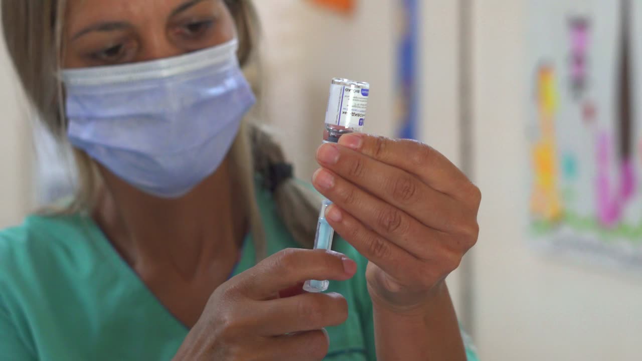A nurse prepares a shot of Sputnik V vaccine. Handheld.