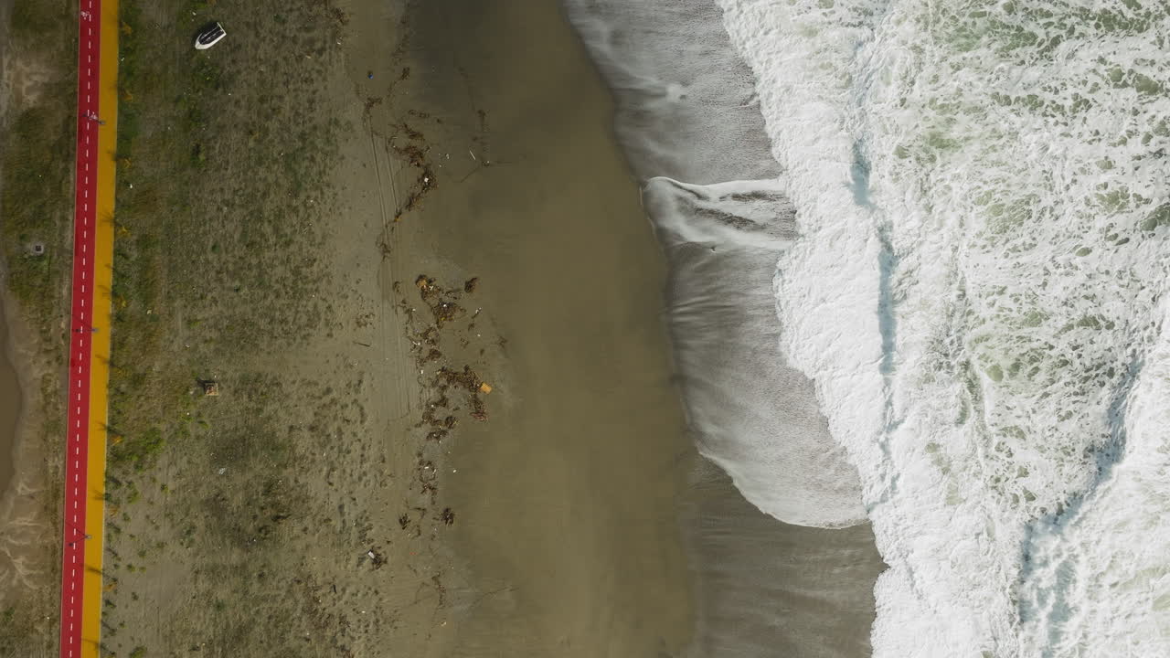 Pista ciclabile vicino alla spiaggia con mare in tempesta