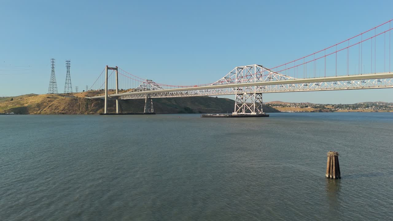 Tranquil skies frame the Alfred Zampa Bridge from above, with sweeping shots revealing the bridge’s elegant structure against Crockett’s historic waterfront