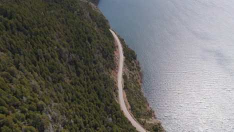 aerial view of a scenic road along a lake in patagonia