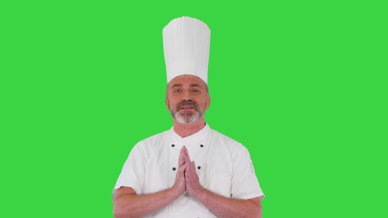 Mature chef talking to camera explaining something on a Green Screen, Chroma Key