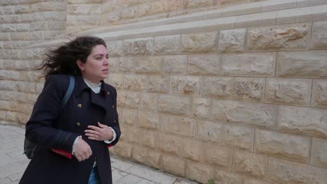 tourist walks down a narrow alley in the old city of jerusalem, israel. slow motion.