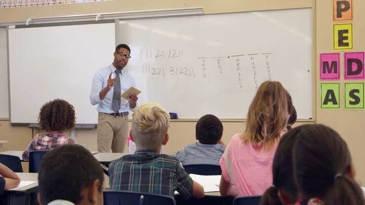 Teacher with tablet computer takes a math class, shot on R3D