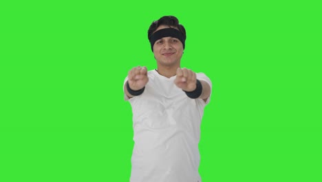 Happy-Indian-man-doing-wrist-exercise-Green-screen
