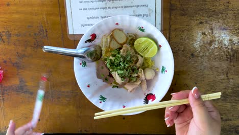 chopsticks and noodles at a bangkok market