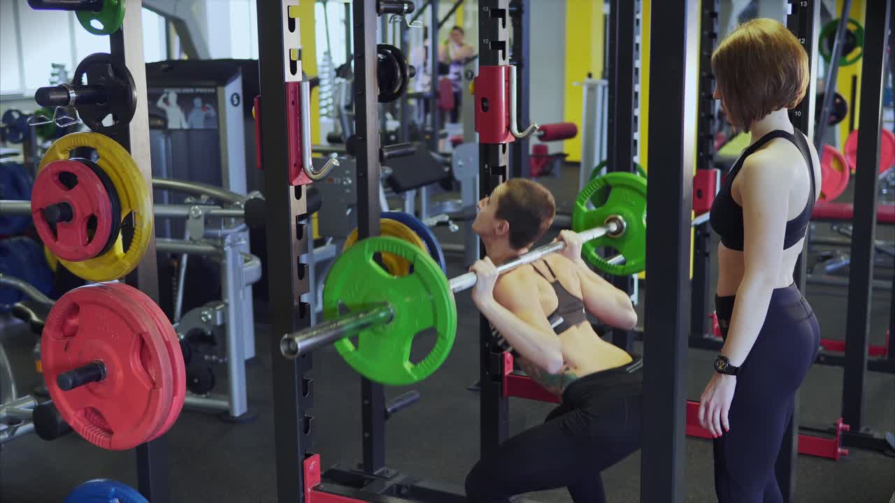 Woman weightlifting squat in gym