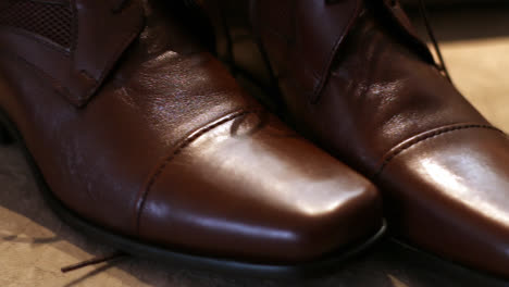 close up gimbal left shot of groom shoes for wedding ceremony