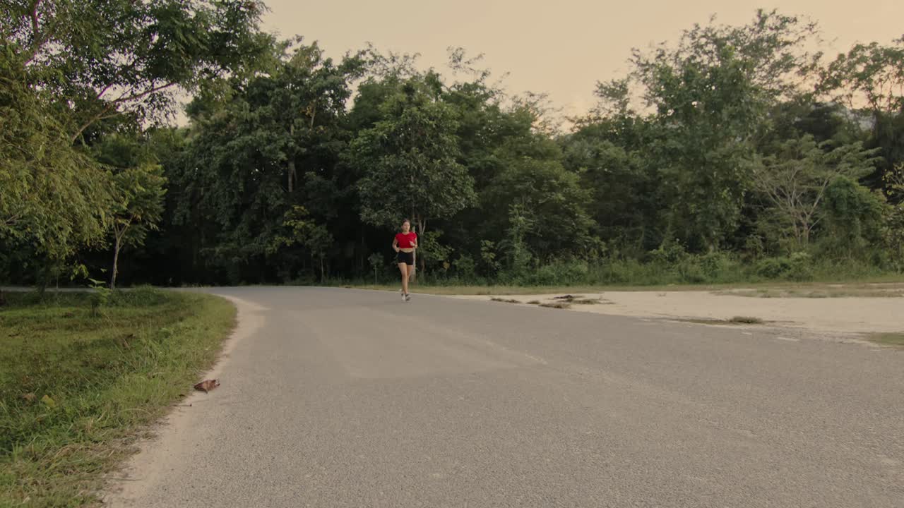 Woman running on a forest road